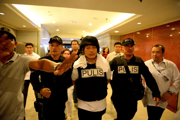 SUSPECT. Police officer Ricky Sta Isabel (C), one of the suspects in the kidnapping and murder of South Korean businessman Jee Ick Joo, is escorted by fellow policemen as they leave the National Bureau of Investigation building in Manila on January 20, 2016. Photo by Noel Celis/AFP  