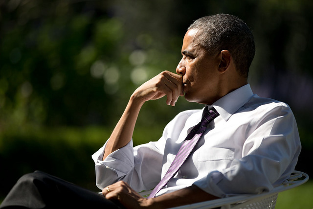 A portrait of US President Barack Obama as he listened during a meeting with staff in the Rose Garden, October 2014. Official White House Photo by Pete Souza